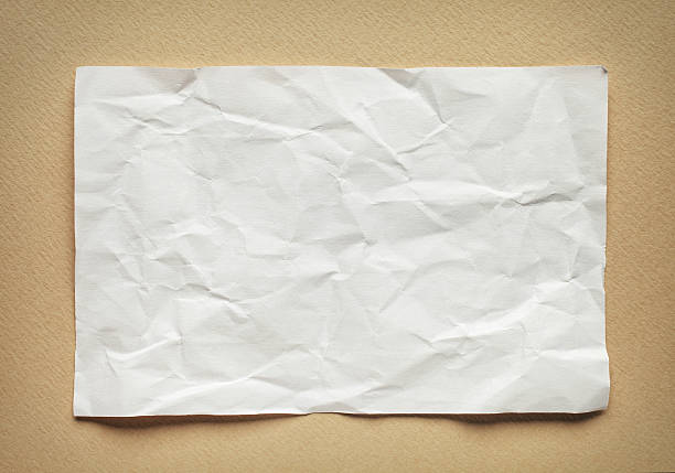 istock Crumpled  white paper card on beige background, place for text 495810796