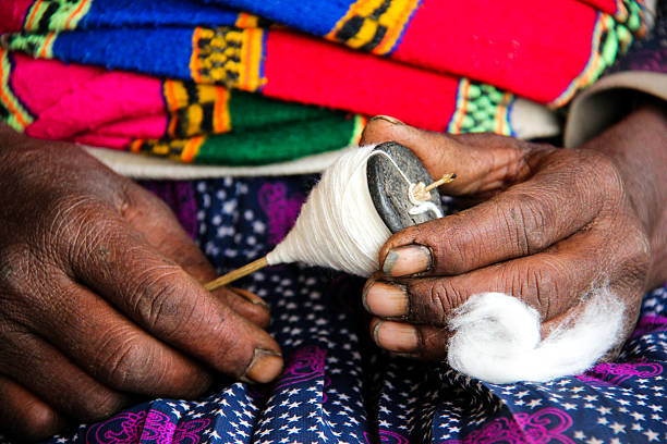 istock Elderly women's hands spinning cotton 495810937