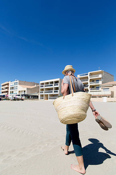 istock Woman walking on Beach 495810959