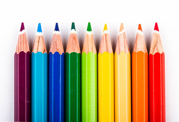 different colored pencils on white background stock photo