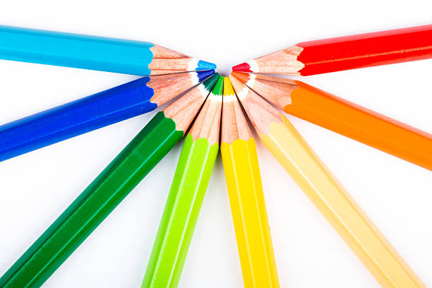 different colored pencils on white background stock photo