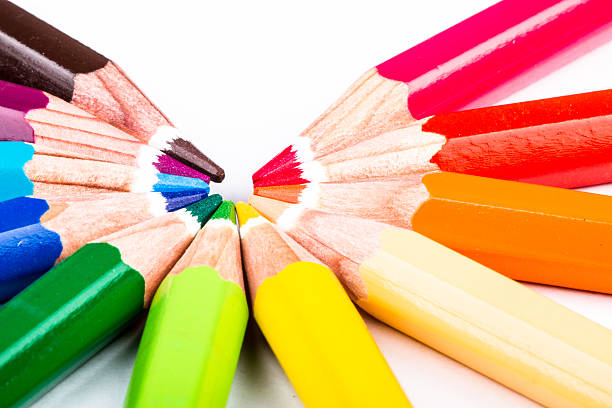 different colored pencils on white background stock photo