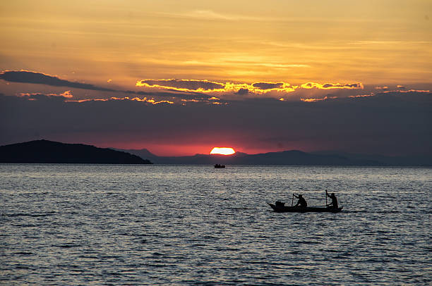 istock African Fishermen paddling infront of sunset 495811706