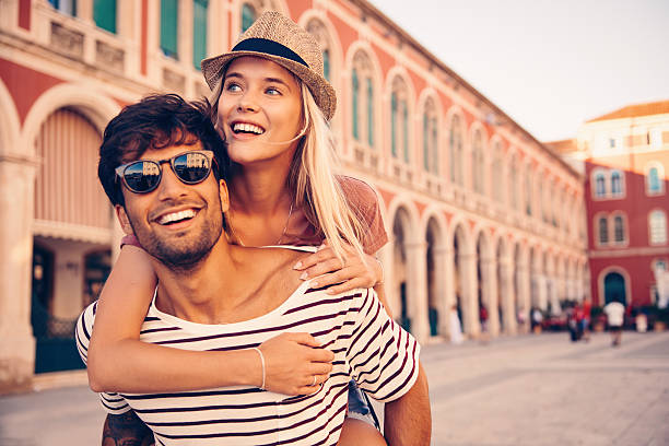 Go and see all you possibly can Shot of a young man piggybacking his girlfriend through a foreign cityhttp://195.154.178.81/DATA/i_collage/pu/shoots/805861.jpg tourist couple candid travel stock pictures, royalty-free photos & images