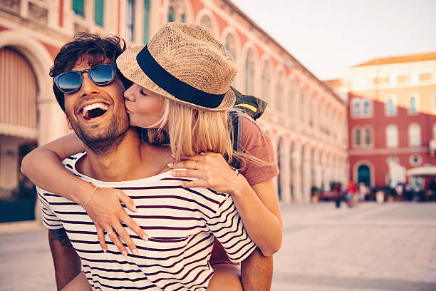 To travel is to follow your bliss Shot of a young man piggybacking his girlfriend through a foreign cityhttp://195.154.178.81/DATA/i_collage/pu/shoots/805861.jpg weekend activities photos stock pictures, royalty-free photos & images