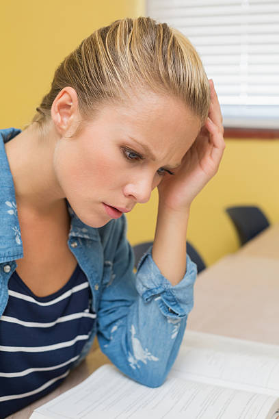 istock Stressed out blonde student in classroom studying 495812707