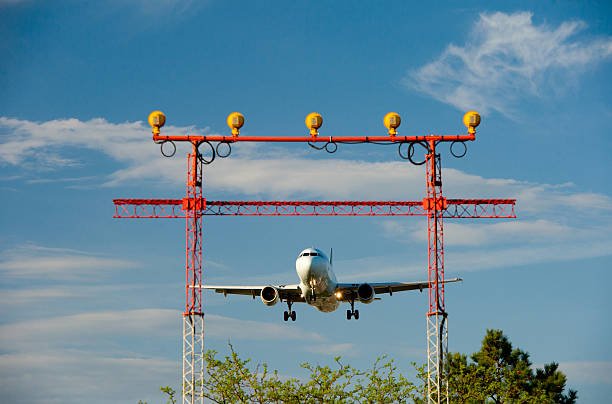 istock passenger plane fly down over take-off runway from airport 495813547