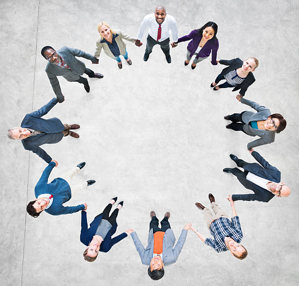 istock Cheerful Business People Holding Hands Forming a Circle 495815087