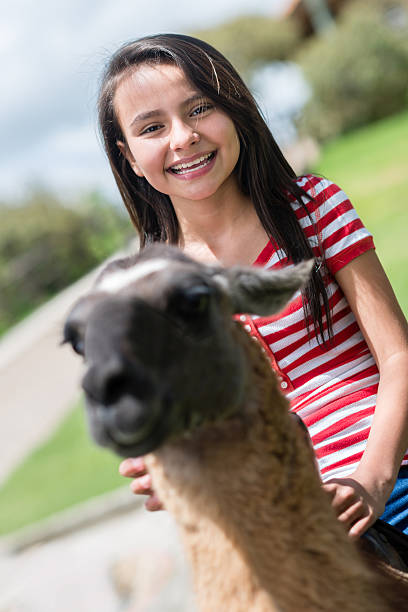 istock Girl riding a llama 495816483