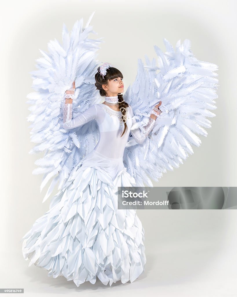 One day I'll fly away Beautiful angel girl spreading her arms with wings on white background 16-17 Years Stock Photo