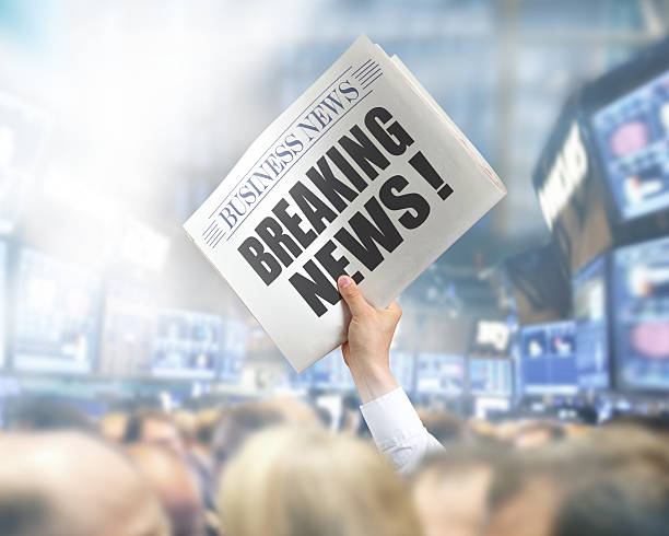 istock Holding Newspaper with Breaking News 495817319