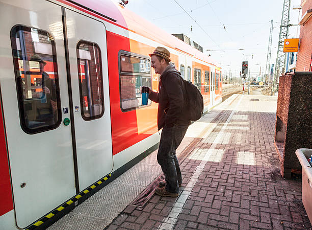 istock young man with coffee mug in front of train 495817523