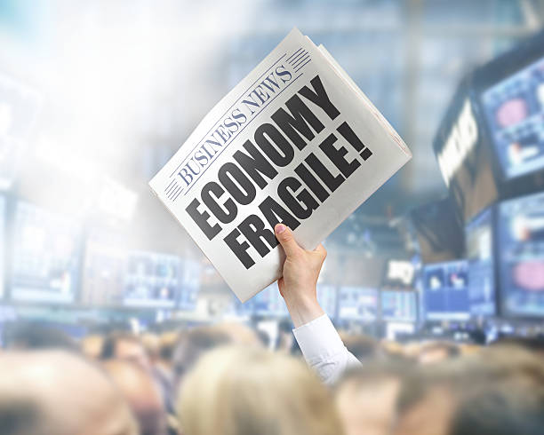 istock Holding Newspaper with Economy Fragile 495817535