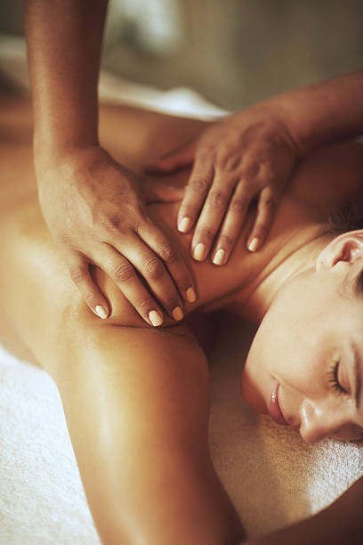It doesn't get anymore relaxing... Shot of a young woman enjoying a back massagehttp://195.154.178.81/DATA/i_collage/pi/shoots/805880.jpg spa lady stock pictures, royalty-free photos & images