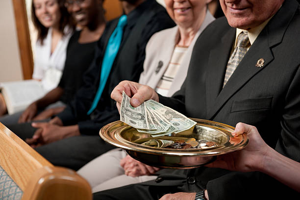 istock Putting Money in a Collection Plate 495828142