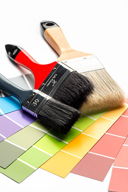 istock three paint Brushes and color swatches on white background 495828578