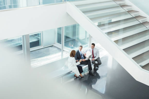 istock Doctor and administrators talking in hospital lobby 495829493
