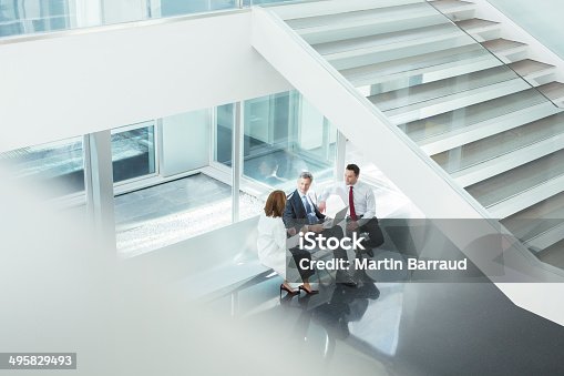 istock Doctor and administrators talking in hospital lobby 495829493
