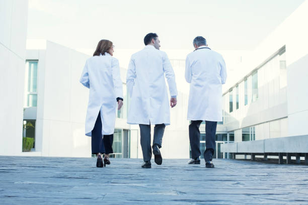 Doctors walking on rooftop  laboratory coat stock pictures, royalty-free photos & images