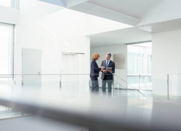 istock Business people with digital tablet in office corridor 495829715