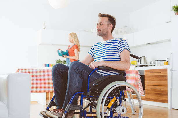 istock Disabled man sitting in a wheelchair at home 495830198