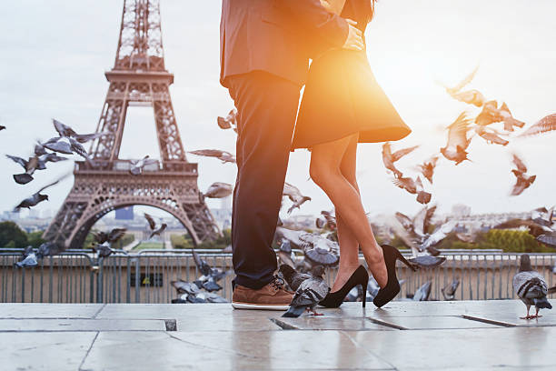 couple near Eiffel tower in Paris couple near Eiffel tower in Paris, romantic kiss paris fashion stock pictures, royalty-free photos & images
