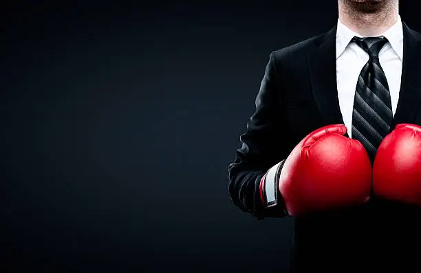 Photo of businessman in boxing gloves