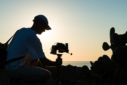 Man filming at dawn with active stabilized rig