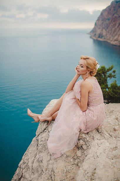 istock Beautiful bride on a cliff top overlooking the sea 495838676