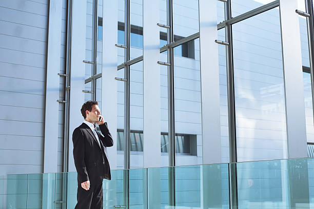istock young business man talking by phone 495839948