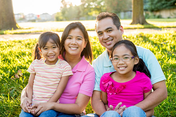 istock Family Sitting Happily at the Park 495841106
