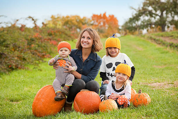 istock Mother And Children At The Pumpkin Patch 495841954