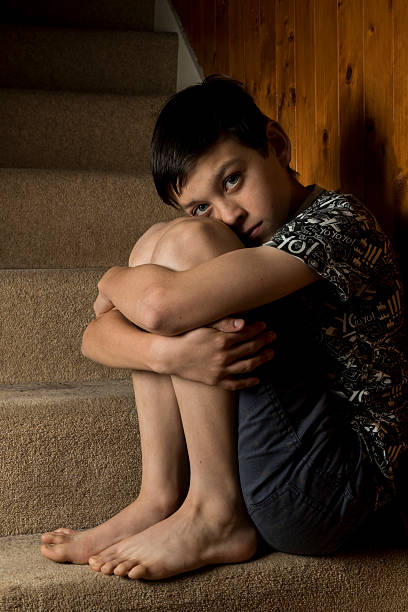 istock Depressed Boy Sitting on Stairs 495842068