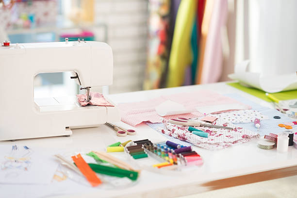 istock closeup on table of seamstress with scissors threads and fabric 495852209