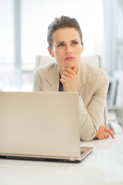 istock thoughtful business woman with laptop at work 495855945