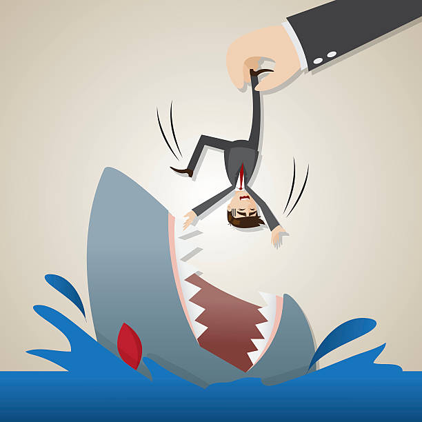 istock cartoon businessman dropped into hungry shark 495856413