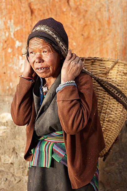 istock Tibetan woman carrying basket 495857627