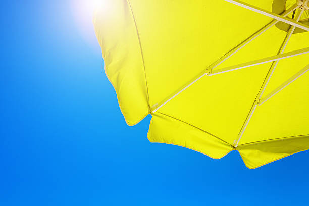 istock Beach umbrella against blue morning sky 495858891