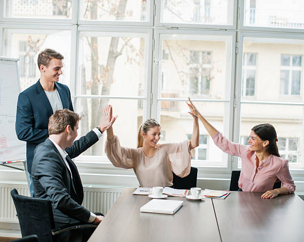 istock Young business team doing high five at conference table 495867133