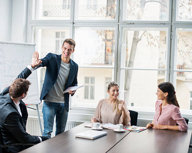 istock Young business team enjoying success at conference table 495867135