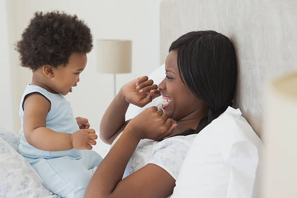 istock Happy mother with cute baby in bed 495867201