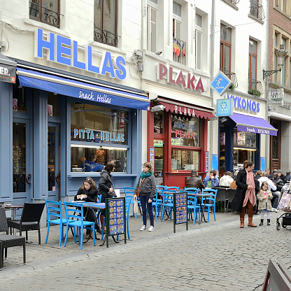 Brussels, Belgium - March 7, 2014: Three Greek restaurants side by side in Brussels. Some people drinking and eating.