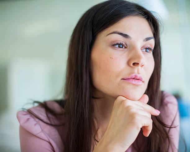 istock Thoughtful young businesswoman looking away in office 495868729