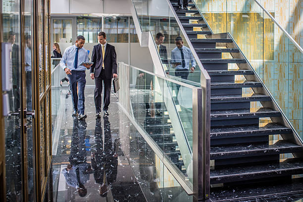 istock Businessmen walking with digital tablet 495869318