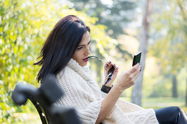 istock Attractive black haired woman using phone 495869800
