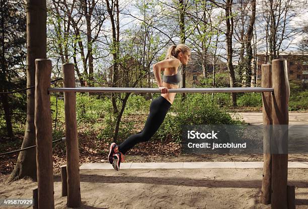 Young Woman Doing Parallel Bar Dips Stock Photo - Download Image Now - Parallel Bars - Gymnastics Equipment, Outdoors, Women