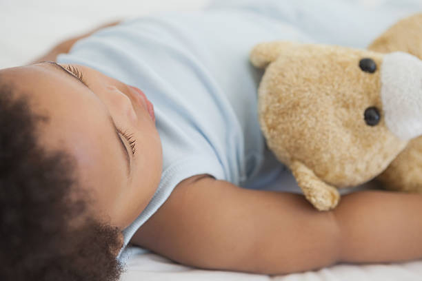 istock Cute little Afro baby sleeping in bed 495871779