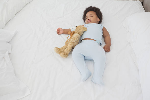 istock Cute little Afro baby sleeping in bed 495871781