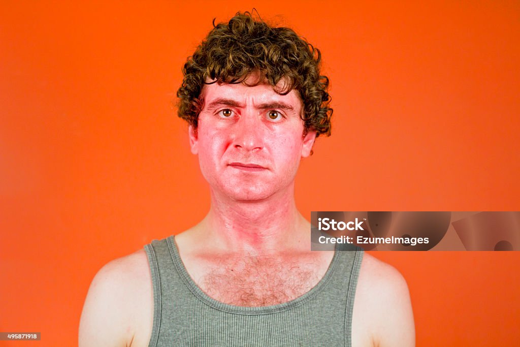 Sunburned Sweaty Man Sunburned sweaty man looks very unhappy in portrait Sunburned Stock Photo
