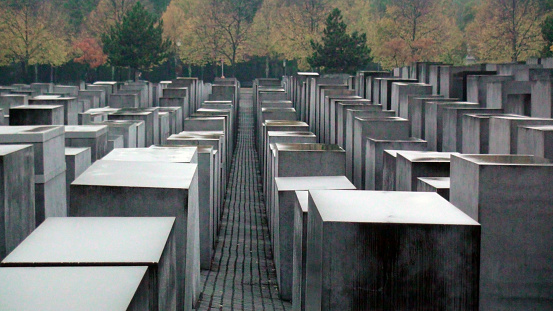 Berlin, Germany - October 15, 2015: View Of Memorial To The Murdered Jews Of Europe.In Autumn In Berlin Germany,Europe.The Memorial To The Murdered Jews Of Europe Also Known As The Holocaust Memorial Is A Memorial In Berlin To The Jewish Victims Of The Holocaust.There Are 2.711 Concrete Blocks Organized In Rows. Building Began On April 1 2003 And Was Finished On December 15 2004. It Was Inaugurated On May 10 2005 Sixty Years After The End Of World War II And Opened To The Public Two Days Later. It Is Located One Block South Of The Brandenburg Gate In The Friedrichstadt Neighborhood In Berlin Germany,Europe.